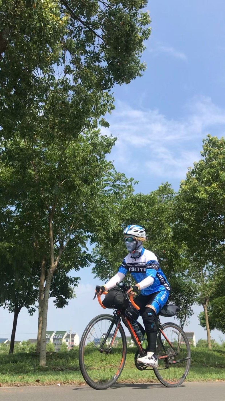 William cycling outdoors on a sunny day